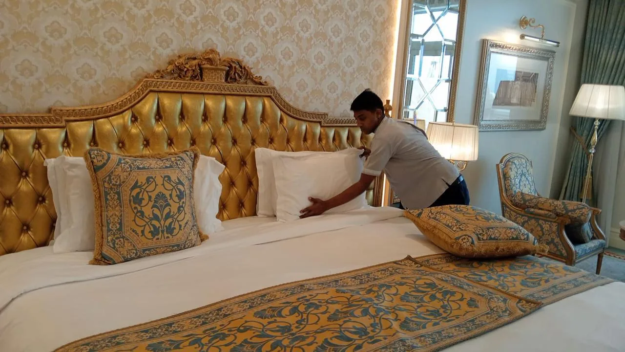 Housekeeping staff making up a bed