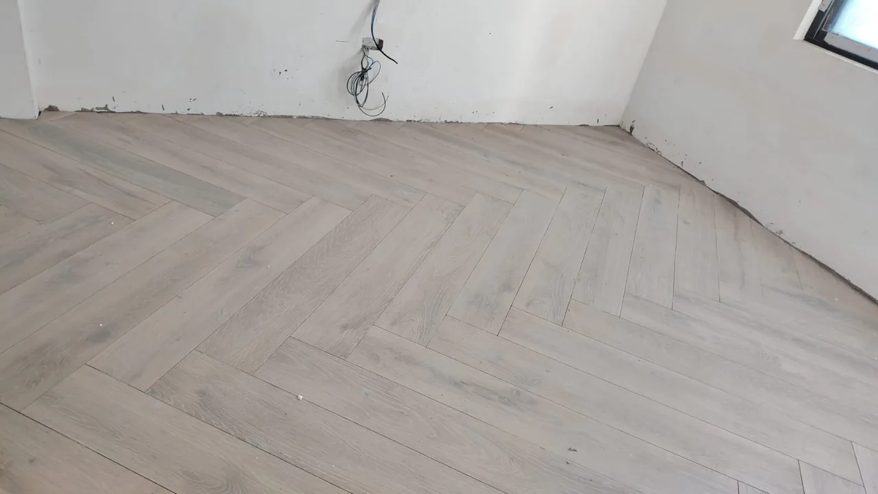 Wood-look herringbone floor across an open room