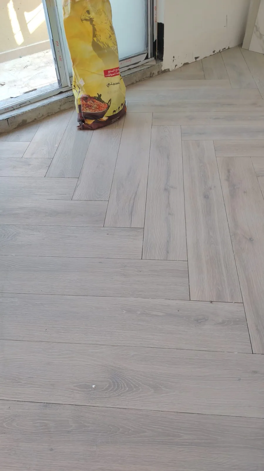 Herringbone floor laid up to a sliding glass door